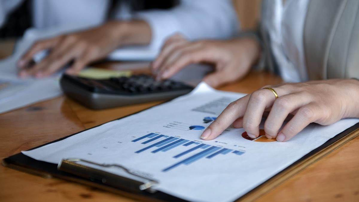 Two  people looking at a bar graph