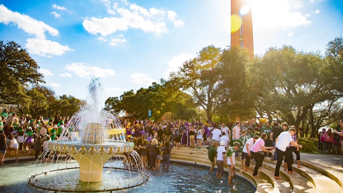 Dozens of Fraternity and Sorority members gather in Miller Fountain during a sunny Bid Day