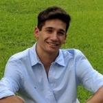 Headshot of Aaron Elfezouaty sitting in the grass